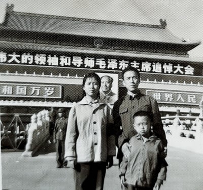 a family posing for a photo in front of a building
